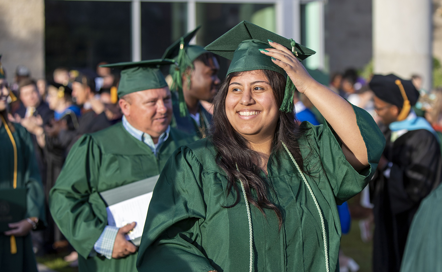 smiling graduate in group
